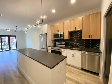 a kitchen with stainless steel appliances and wooden cabinets